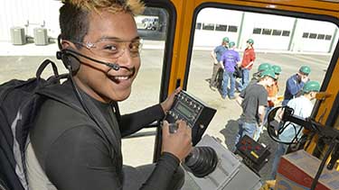 Young man operating heavy equipment