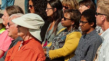 Group of people sitting listening to speaker