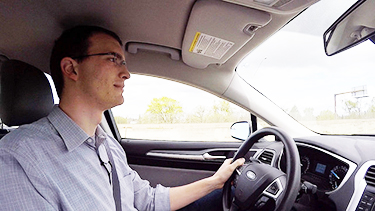 Photo of a man driving a car