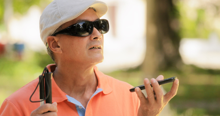  Man with a white can talks on a cell phone.