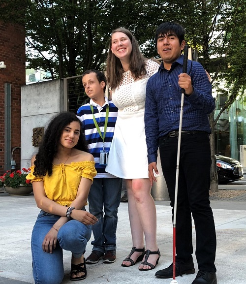 Group of four blind students outdoors.