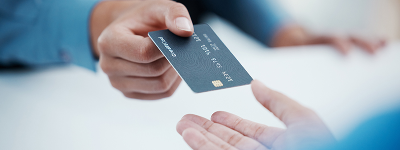 Person giving credit card to another