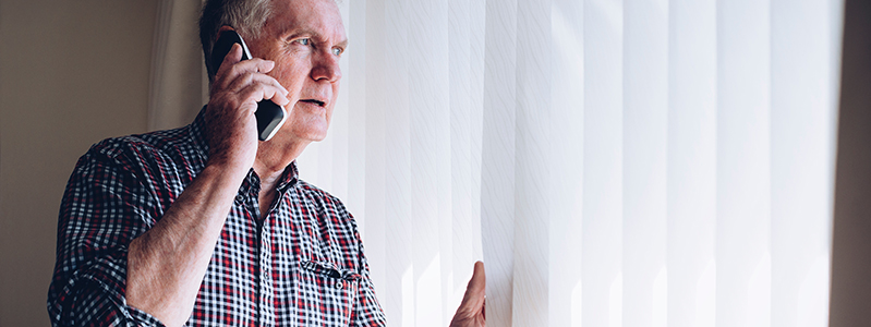 Man on telephone looking out window