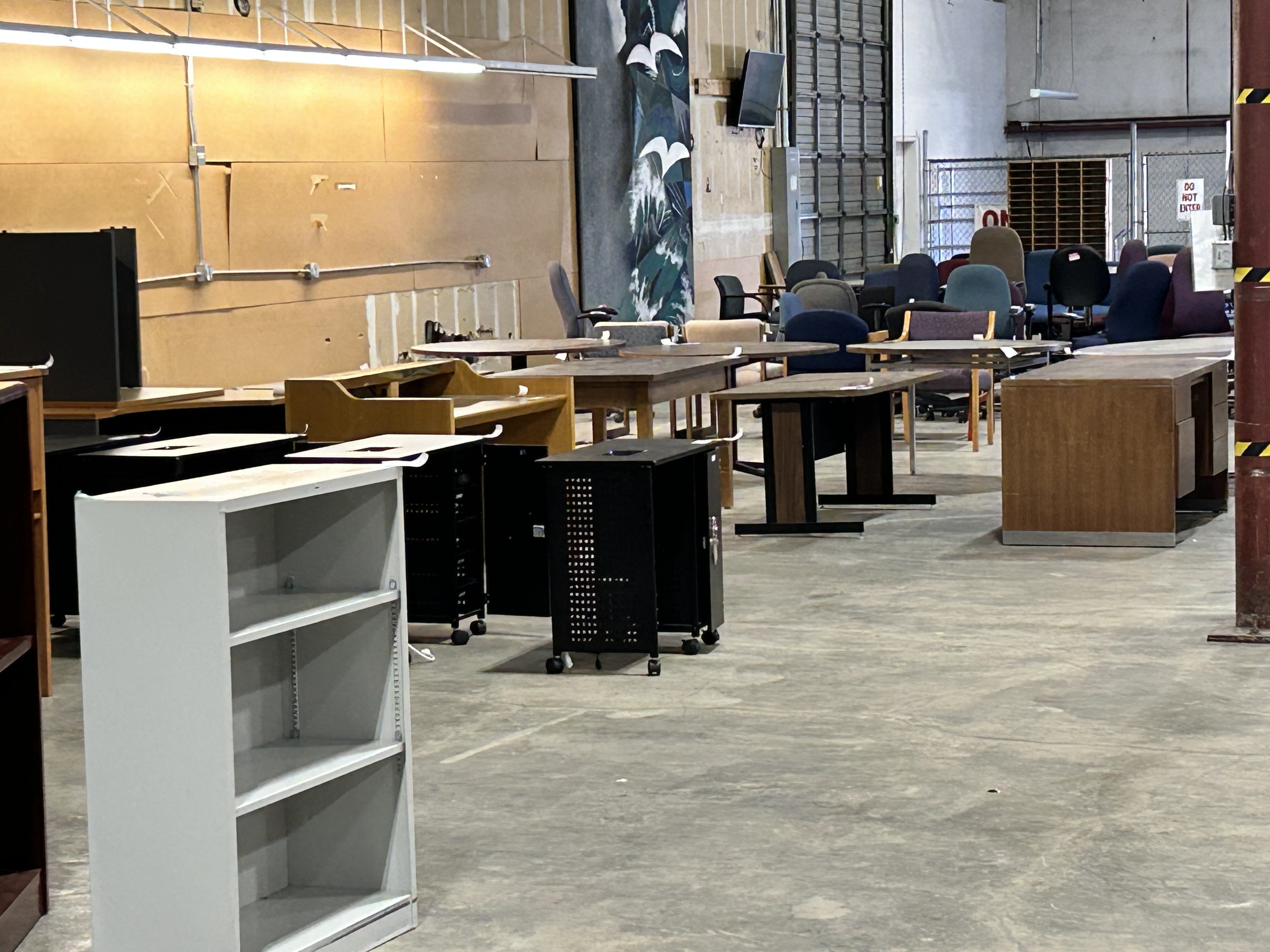 Long view of clustered bookcases, desks and tables