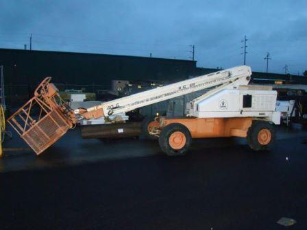 An orange and white cherry picker lift