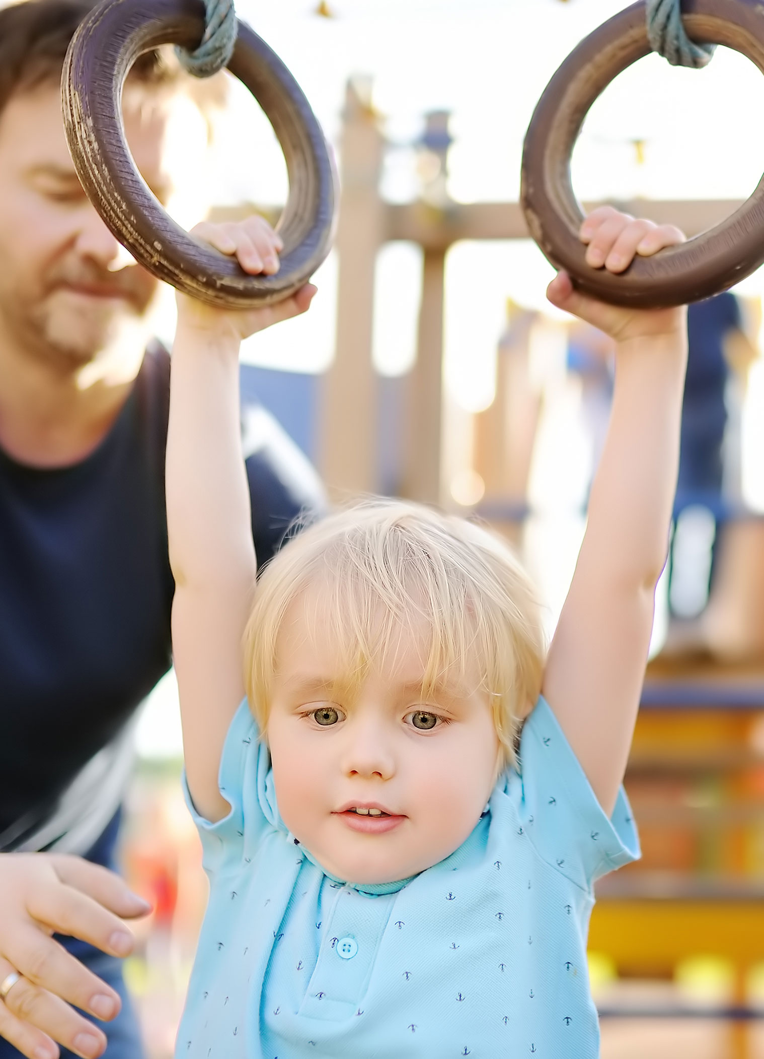 kid playing on rings