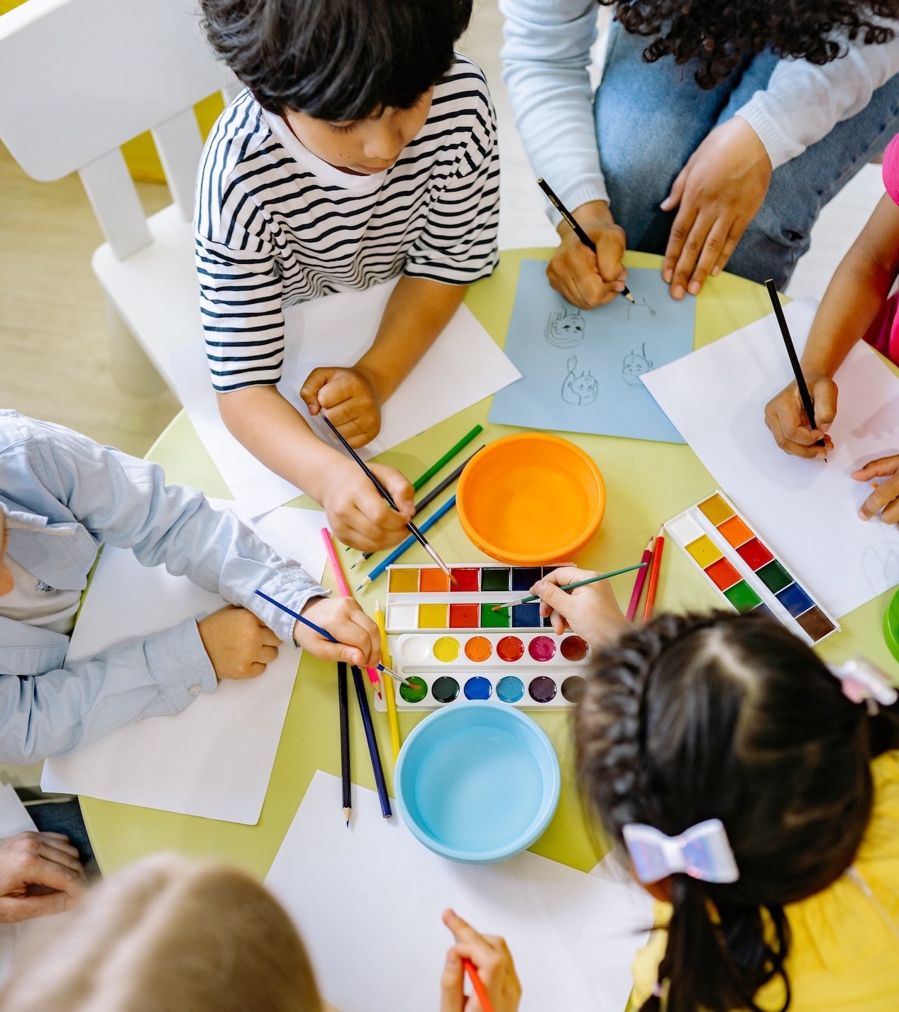 Kids painting around table