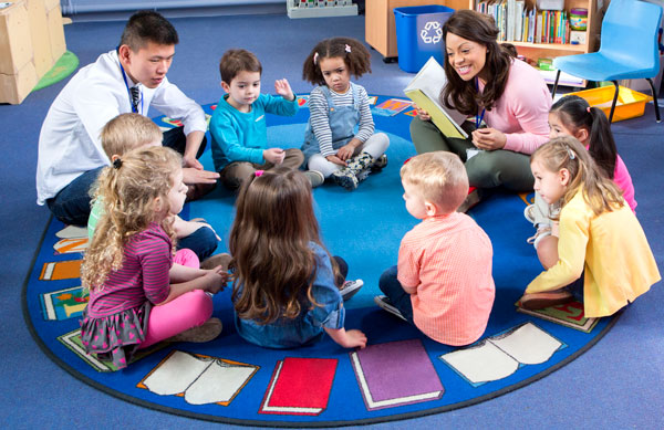 teachers in group with children
