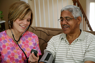nurse-assisting-an-older-gentleman