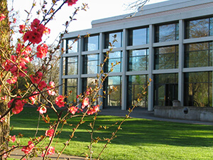Building with flowers blooming in front.