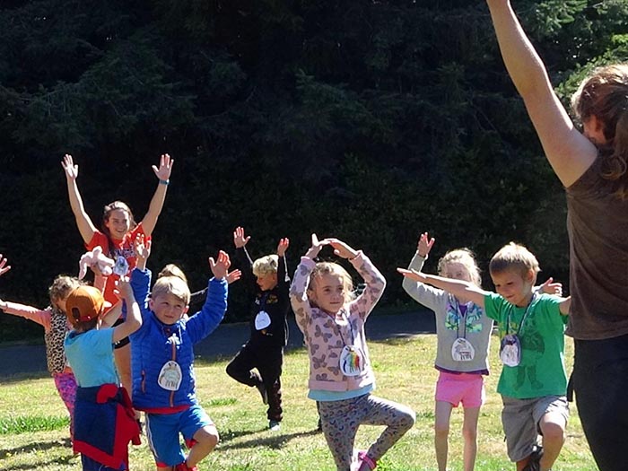 Instructor and kids stand on one leg