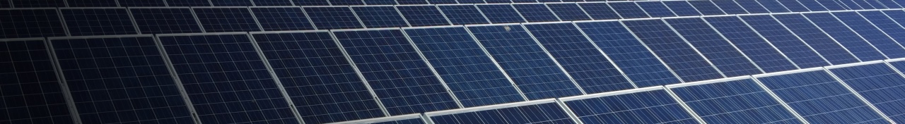 Rows of solar panels in front of a mountain range