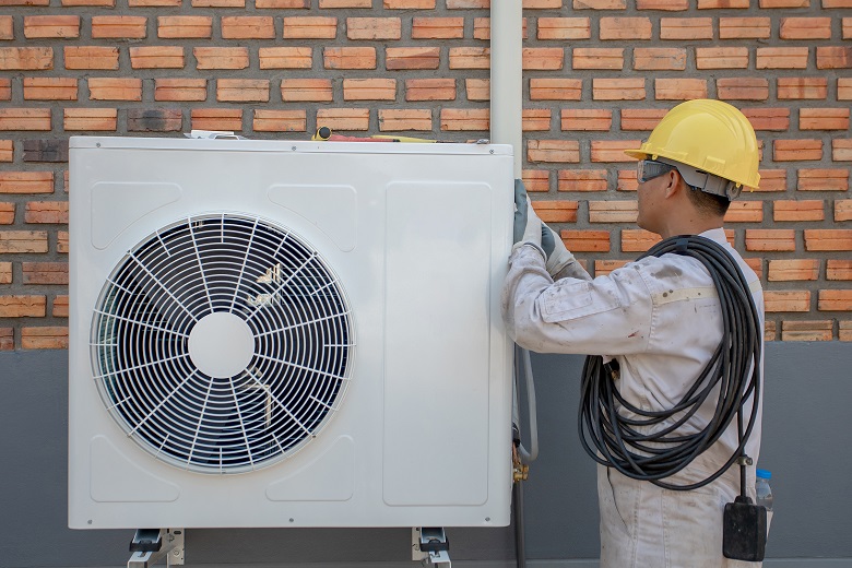 Heat Pump technician preparing to install.jpg