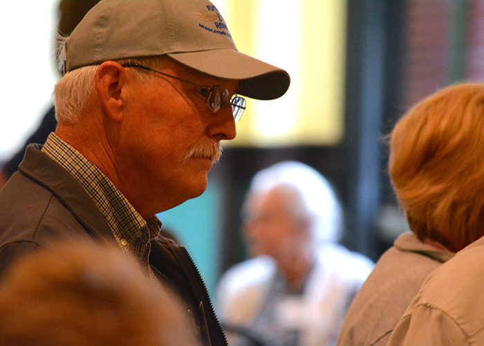 Close up of a man attending a public meeting