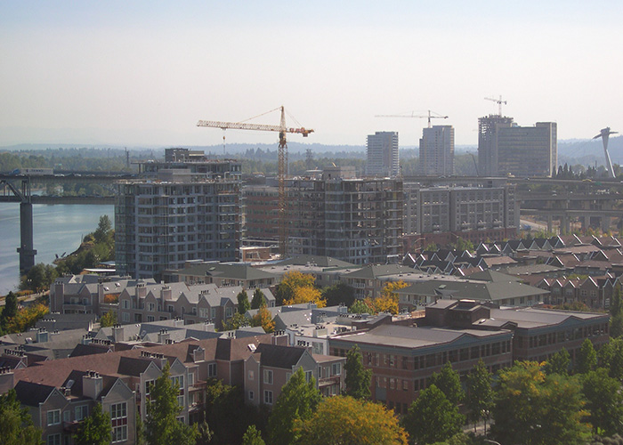 Cranes tower over a city building new apartments and offices
