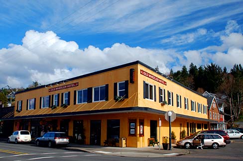 City streetscape with old hotel below blue sky in Wheeler, Oregon.