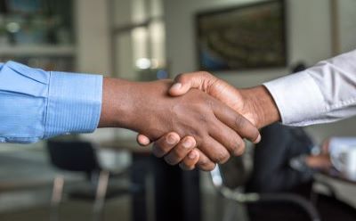 Decorative image of two people shaking hands.
