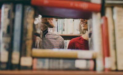 Decorative image of smiling people at a library.