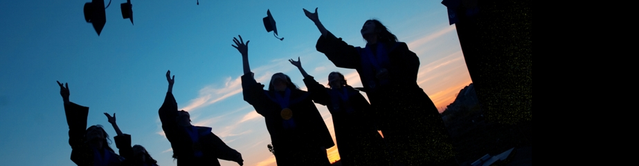 College graduates throwing caps in the air