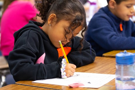 Side view girl writing with pencil