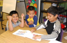 Children reading a book together in a Classroom