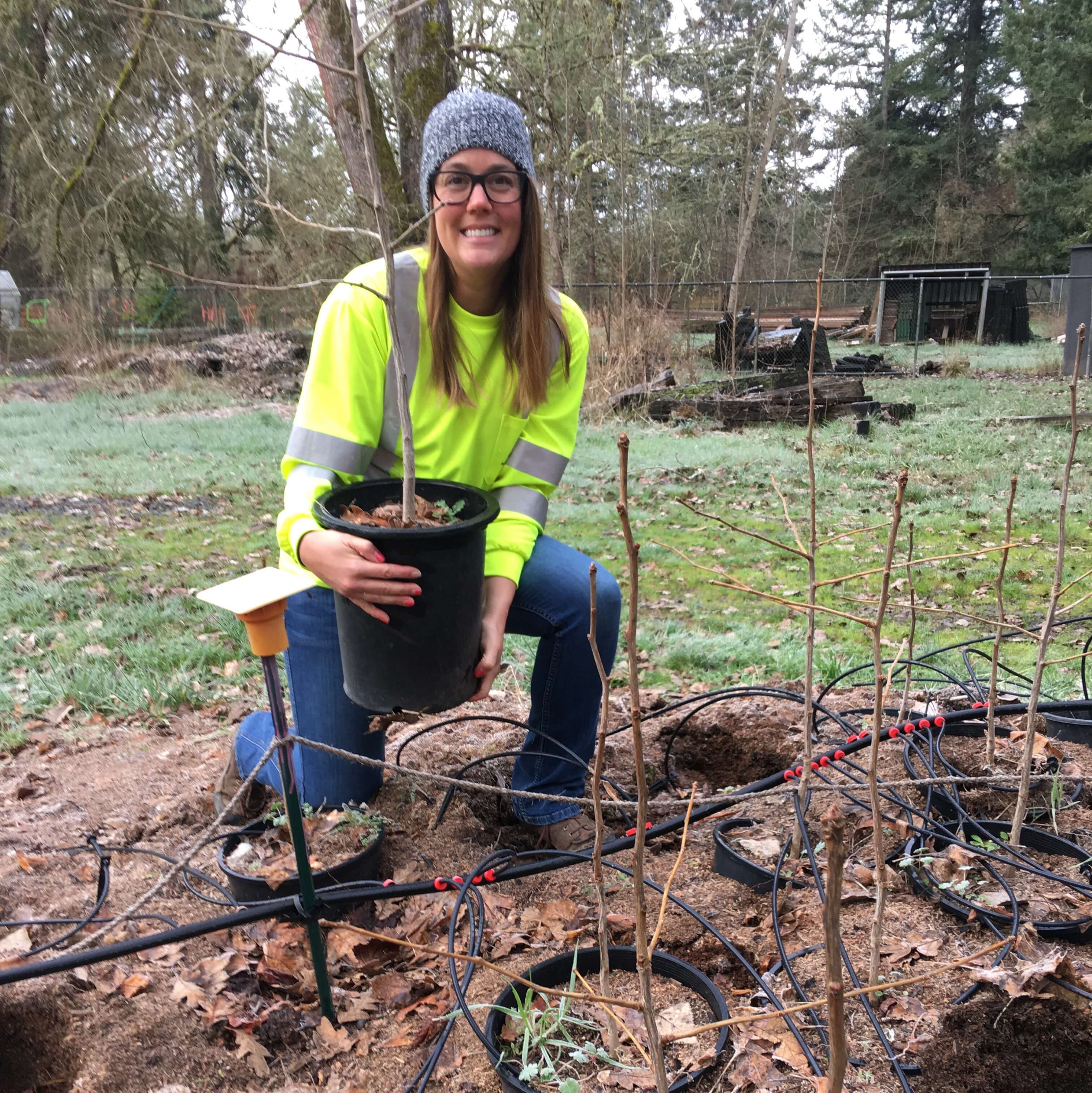 Jennifer Killian with a ginkgo seedling.