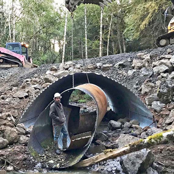A man is standing in a culvert.