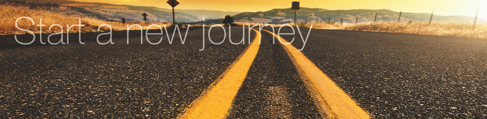 Start a new journey expands on road during sunset with two yellow center lines.png