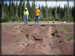 Men standing on edge of bank.