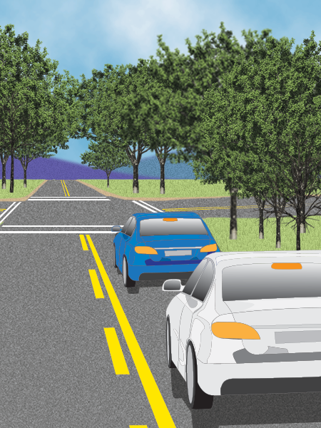 Two cars follow each other. Front car stops for an intersection. They stay in line.