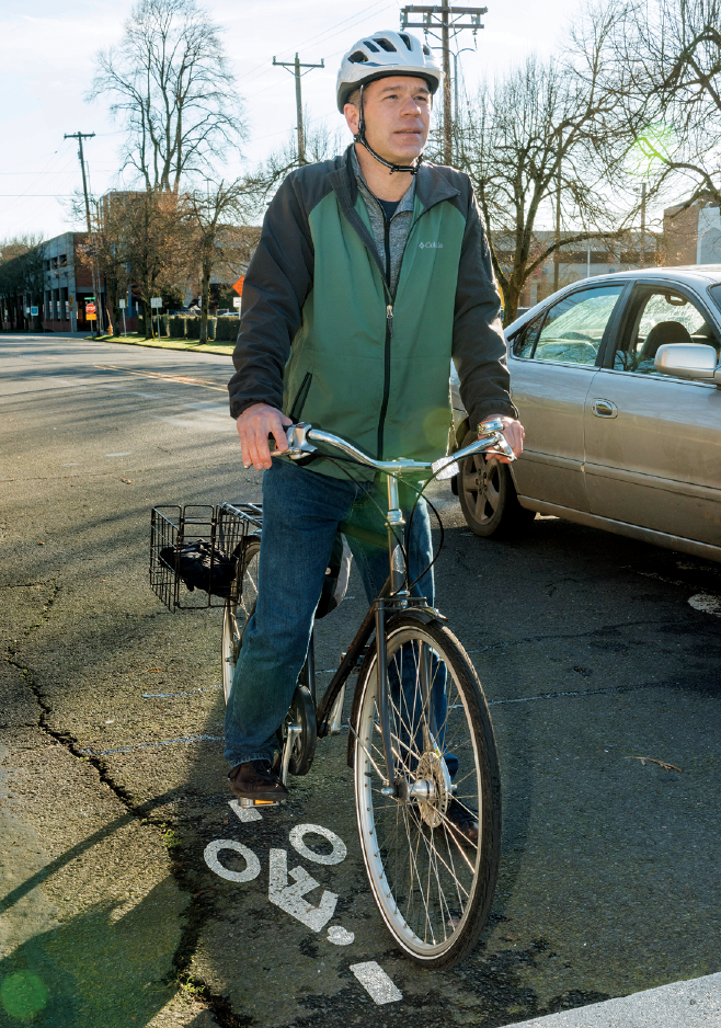 Image - a man on a bicycle stopped on a detector stencil.