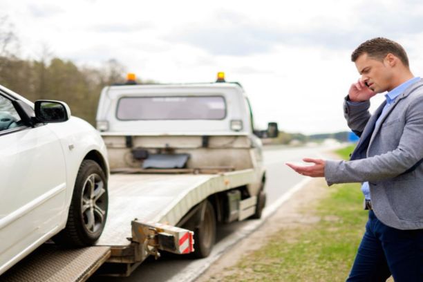 Man on phone with tow truck