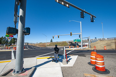Pedestrian waits to cross at intersection