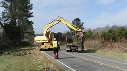 People working on a road with heavy equipment
