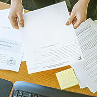 Hands holding ODOT form above desk