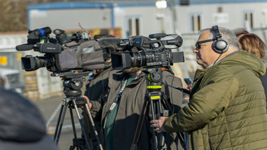 Photo of news crews with tv cameras