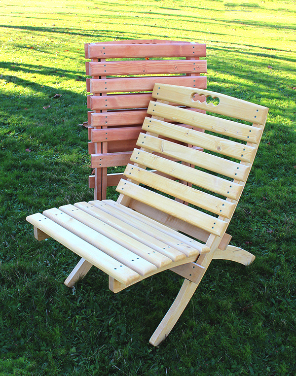chair and ottoman on grass next to outdoor fireplace