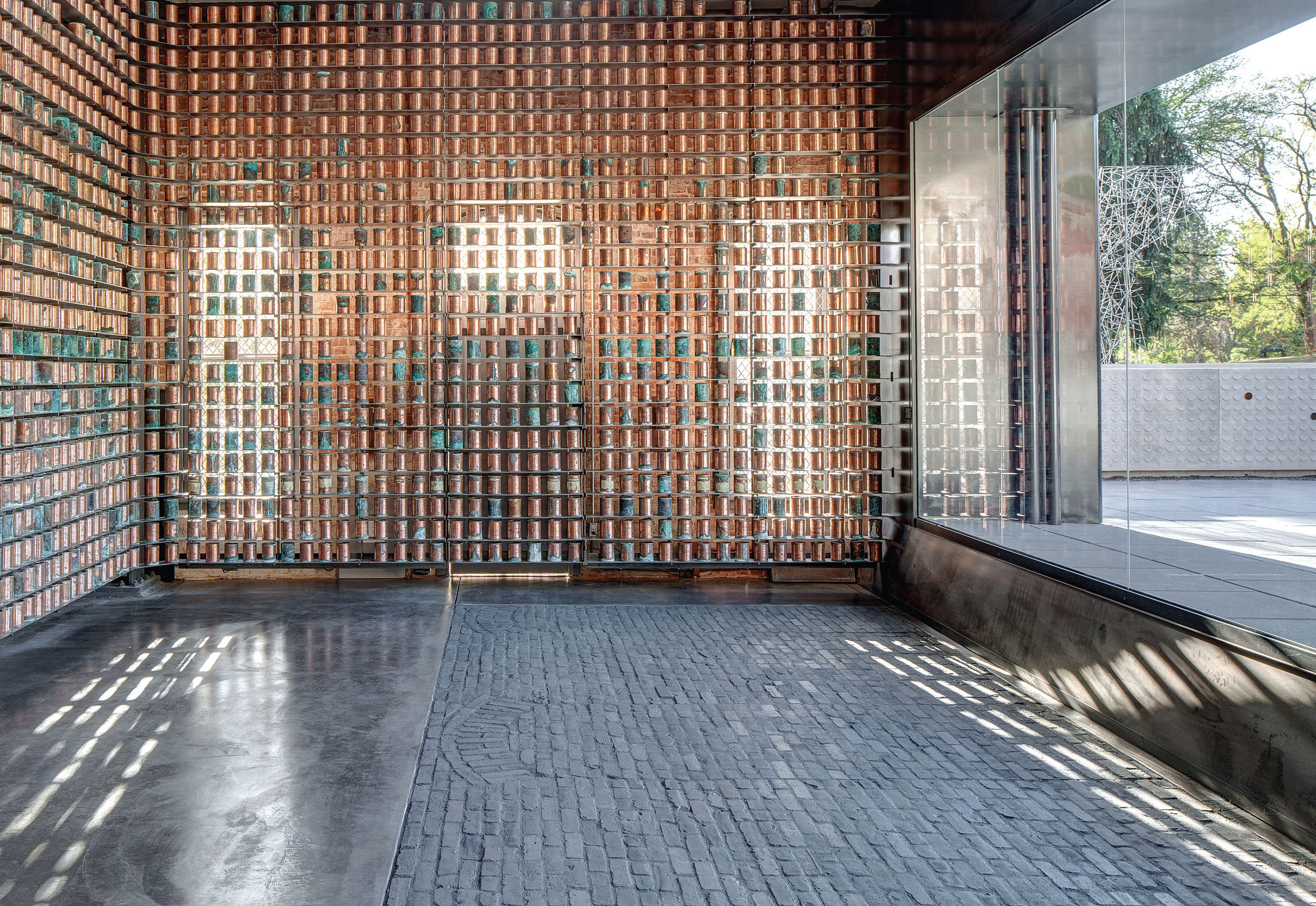 Inside of memorial showing copper urns and brick floor