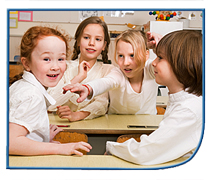 Four girls sitting at desks in a classroom