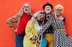 Vibrant senior citizens having fun against a red background Vibrant senior citizens having a good time while standing together a