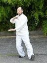 Suman demonstrating the Tai Chi "hold the ball" pose