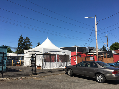 Large enclosed tent with three walls and a ceiling