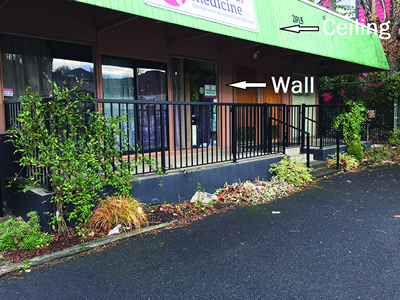 Structure that is not enclosed. The area has one wall and a ceiling.