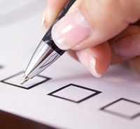 hand with pen checking box on a form