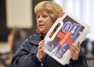 Woman holding up a first aid kit