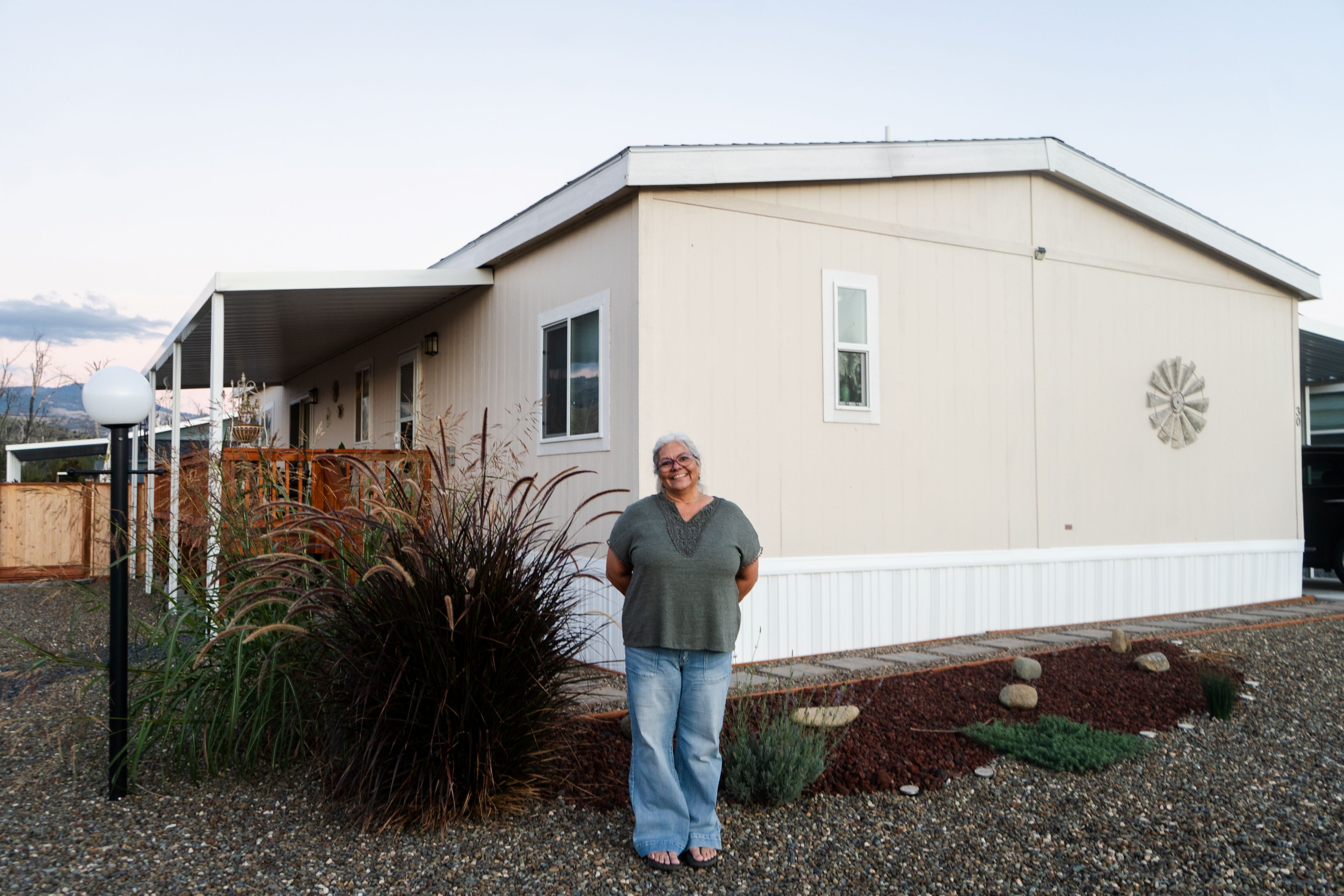 Jeannine in front of her home
