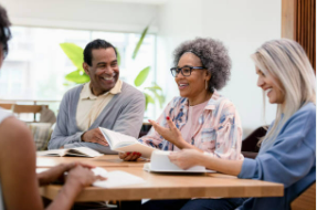 People sitting around a table in an office setting talking