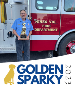 Dave Riess holding his award