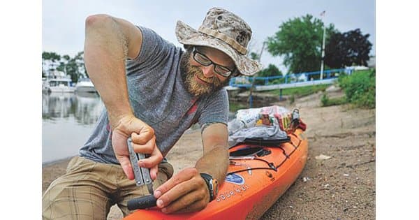 Paddler rigging up a kayak