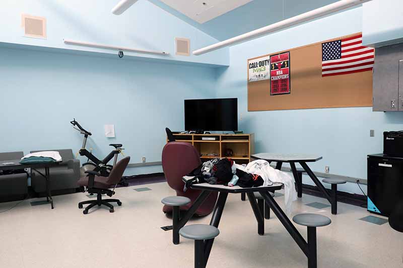 tables and chairs and TV in a room